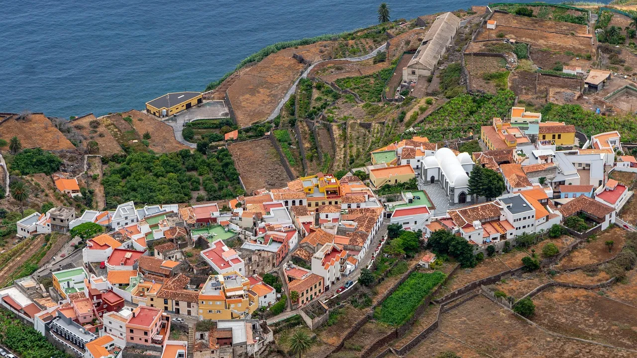 The village of Agulo on La Gomera, with white and colourful houses on a green ridge above the Atlantic Ocean
