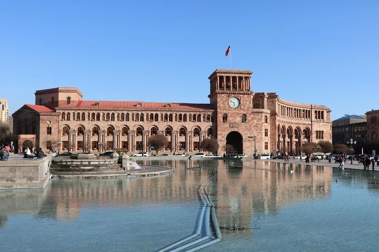 Republic Square in Yerevan, with its pink tuff-stone government buildings and clock tower reflected in the pool of fountains