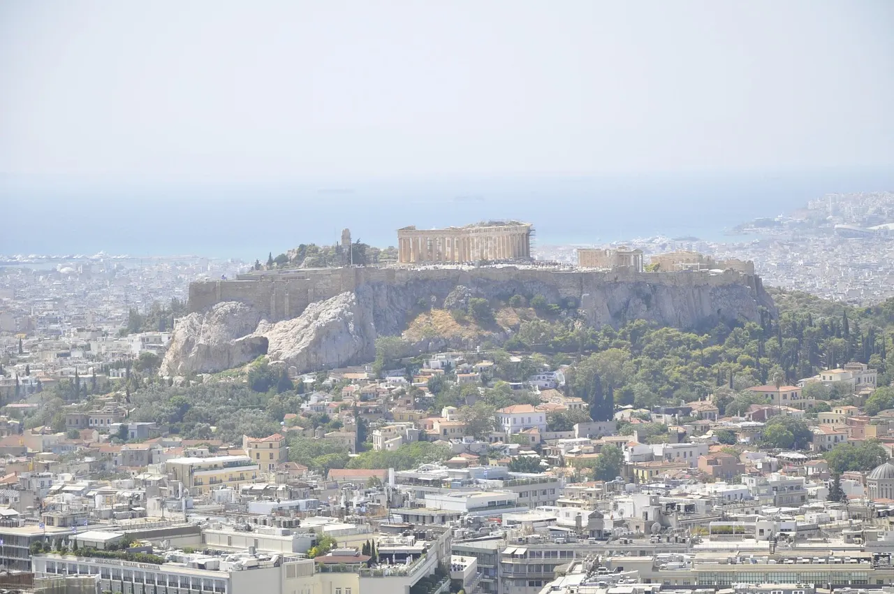 The Acropolis rising on its rocky hill above the white buildings of Athens