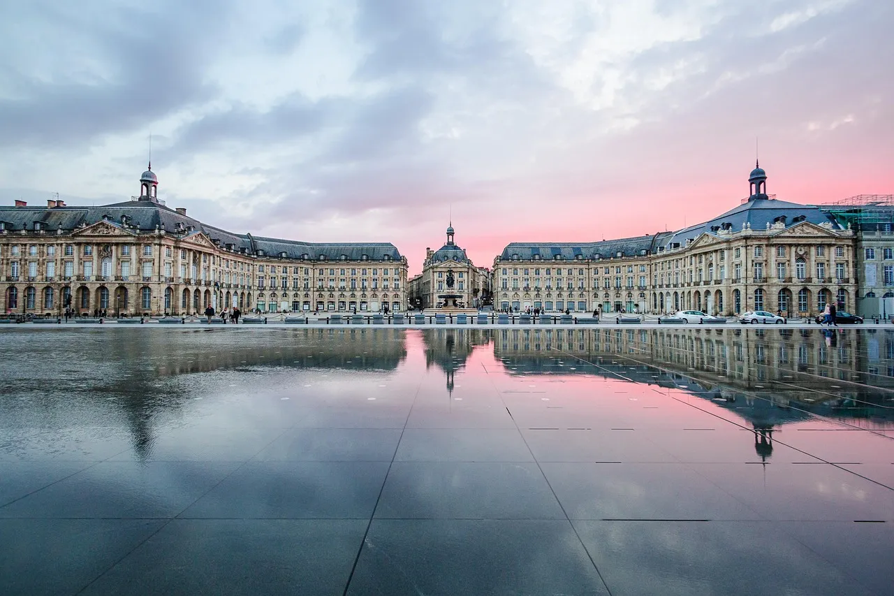 The Place de la Bourse in Bordeaux reflected in the Miroir d'eau at sunset