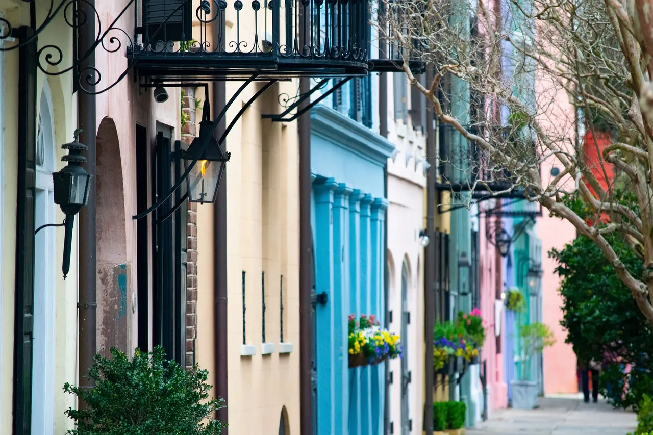 Pastel-painted houses with flower boxes on a street in Charleston