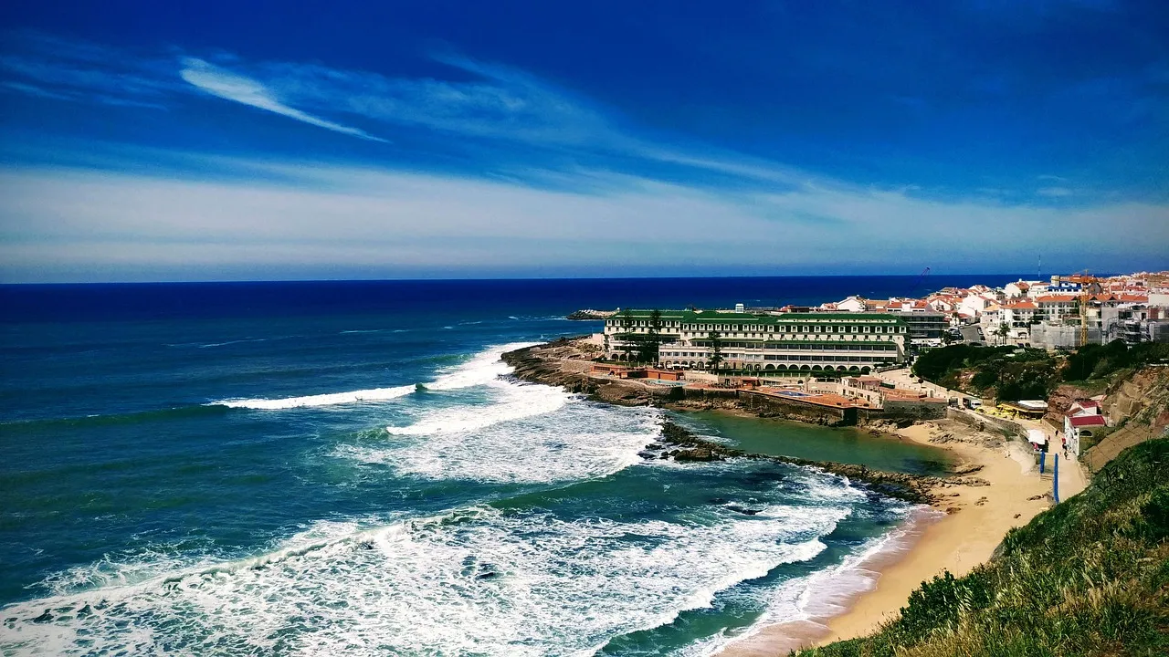 Ericeira's white town on the cliffs above an Atlantic surf beach