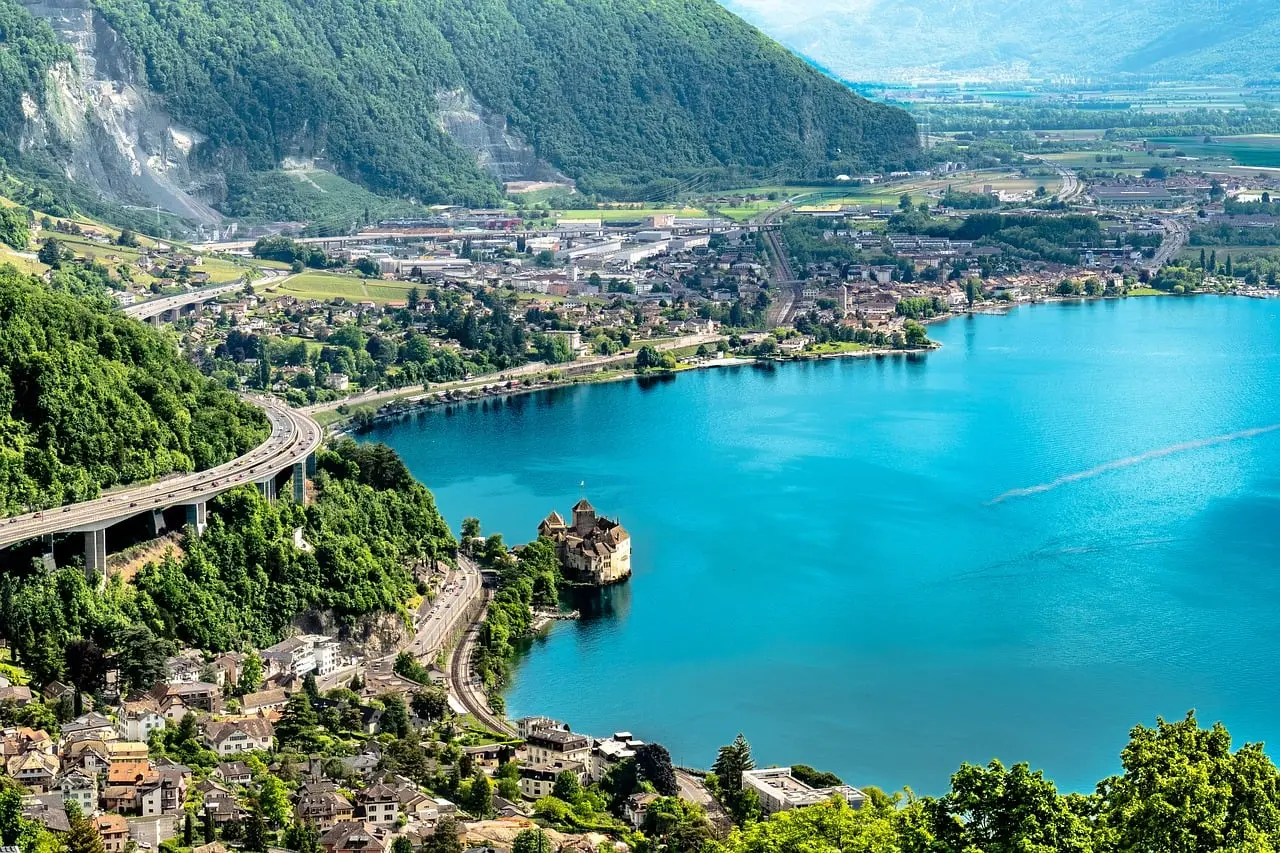 Looking down on Lake Geneva at Montreux, with Chillon Castle on the shore and green mountains around