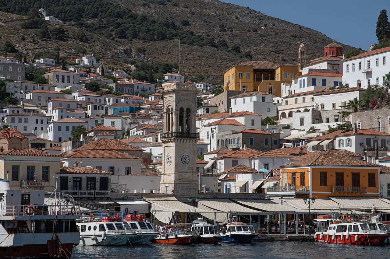 Stone houses and a bell tower around Hydra's harbour