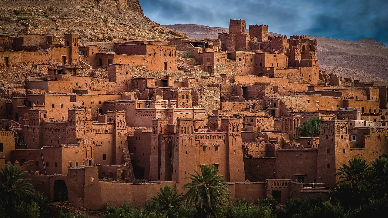The clay-walled ksar of Aït Benhaddou on a hillside in southern Morocco, with palms below