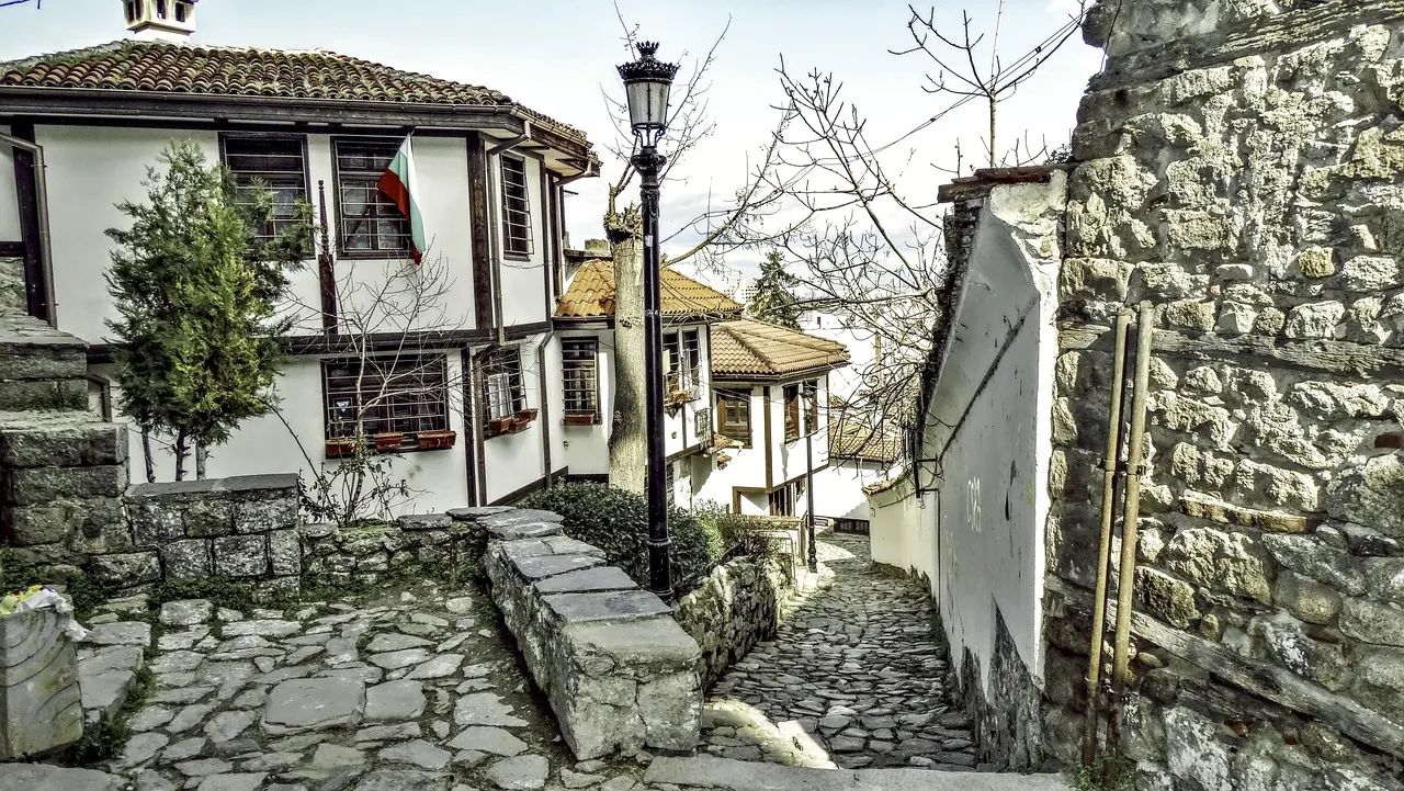 A cobbled lane in Plovdiv's Old Town lined with white-walled revival houses with wooden balconies