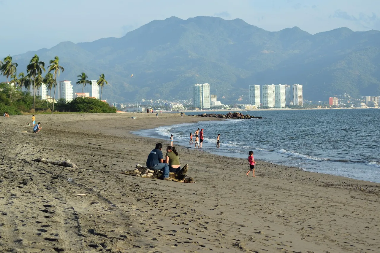 The beach at Puerto Vallarta, with the city and green mountains behind