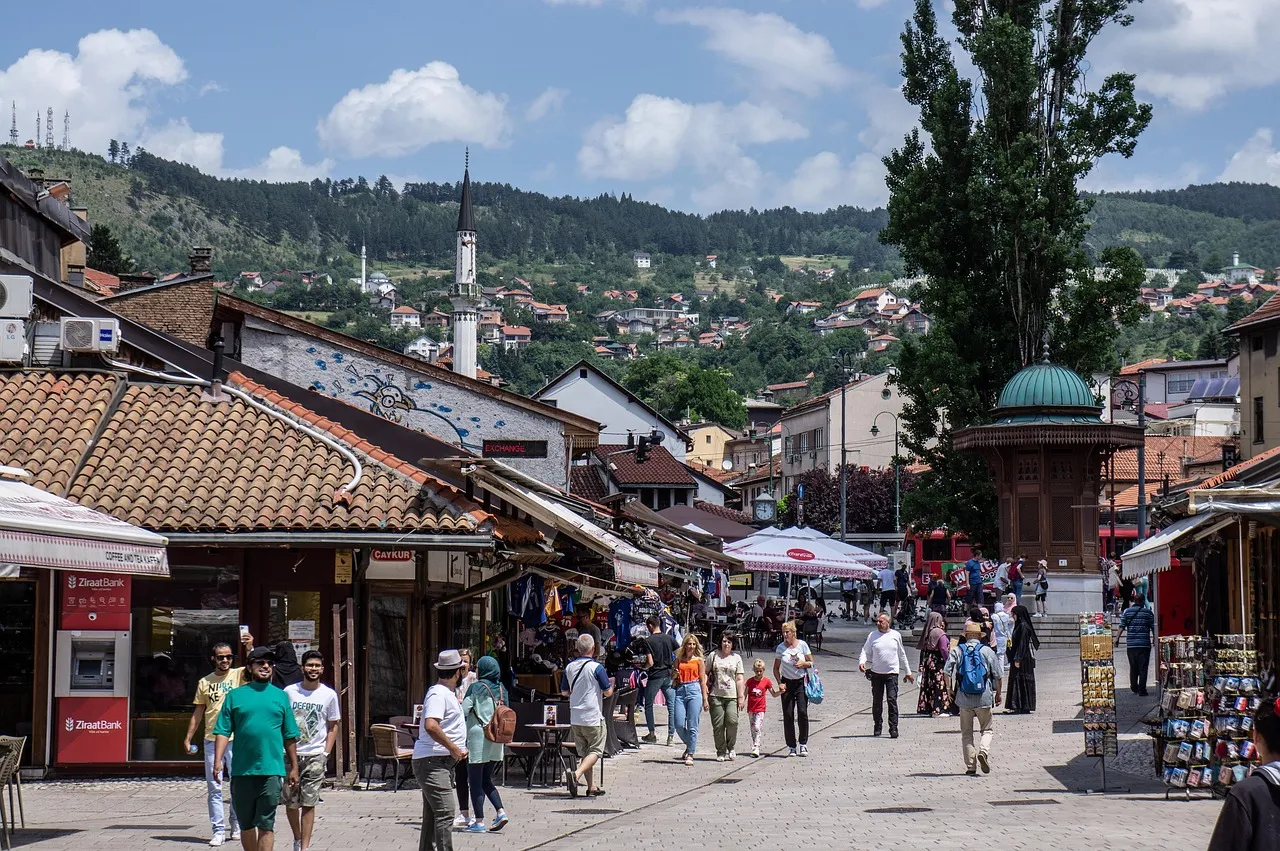 People walking past the wooden Sebilj fountain in Baščaršija, the old Ottoman bazaar quarter of Sarajevo