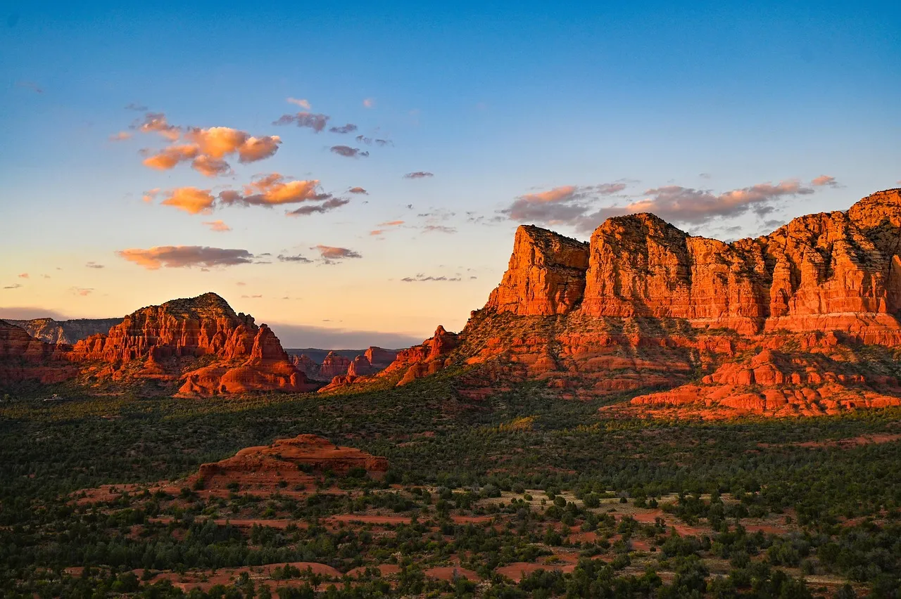 Red-rock buttes glowing at sunset above the desert in Sedona