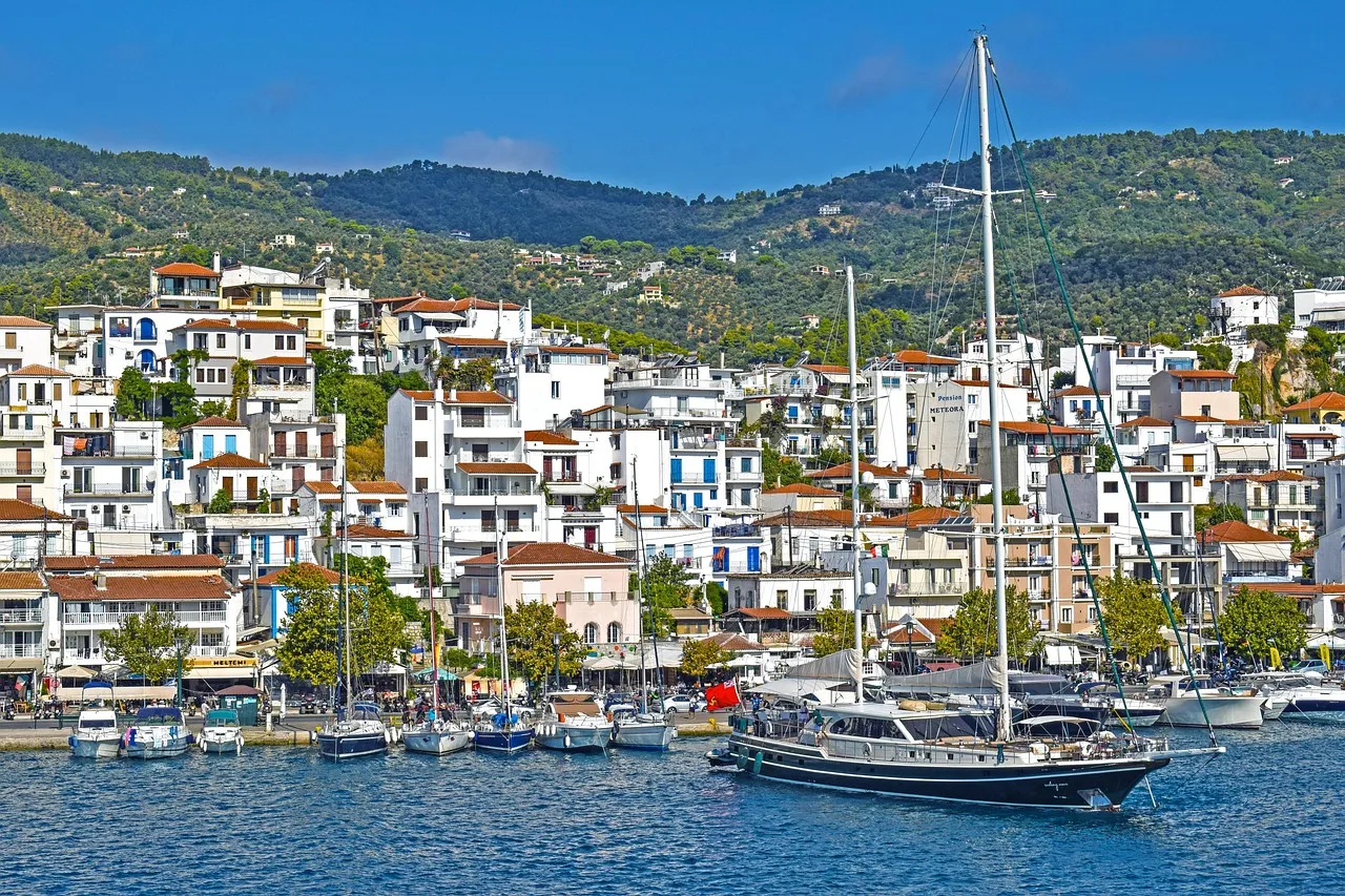 Skiathos town's white houses above the harbour and yachts