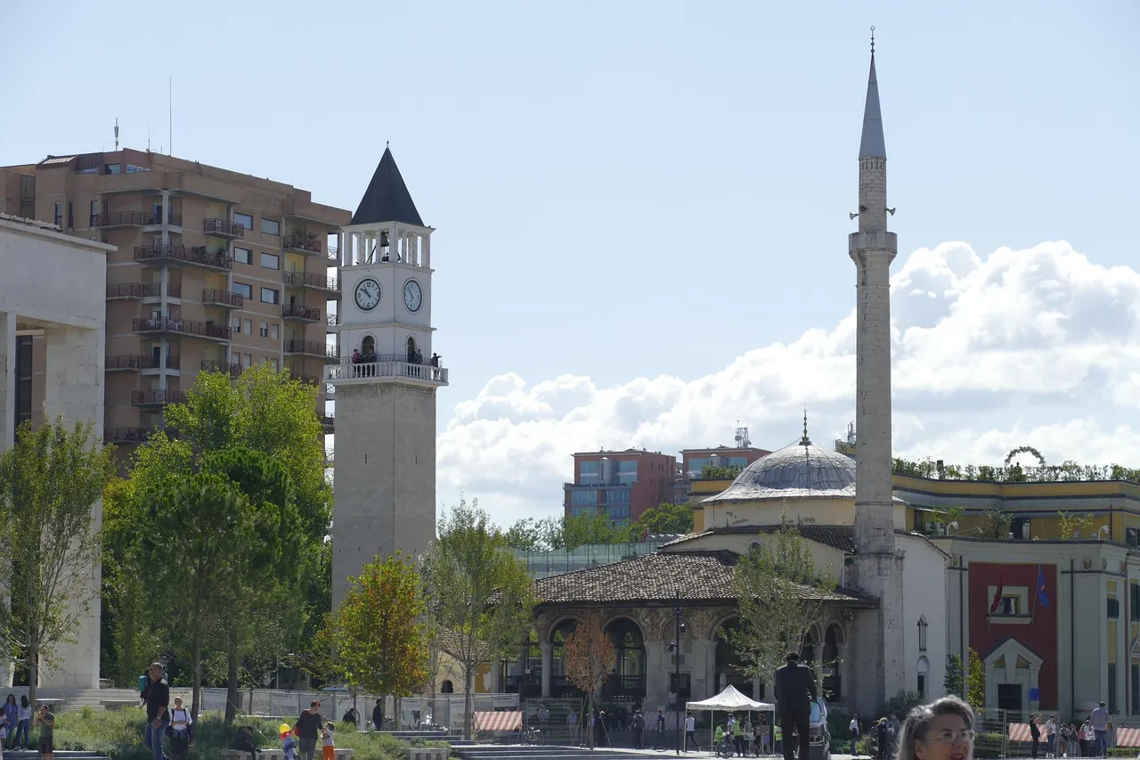 The clock tower and the minaret and dome of the Et'hem Bey Mosque beside Skanderbeg Square in central Tirana
