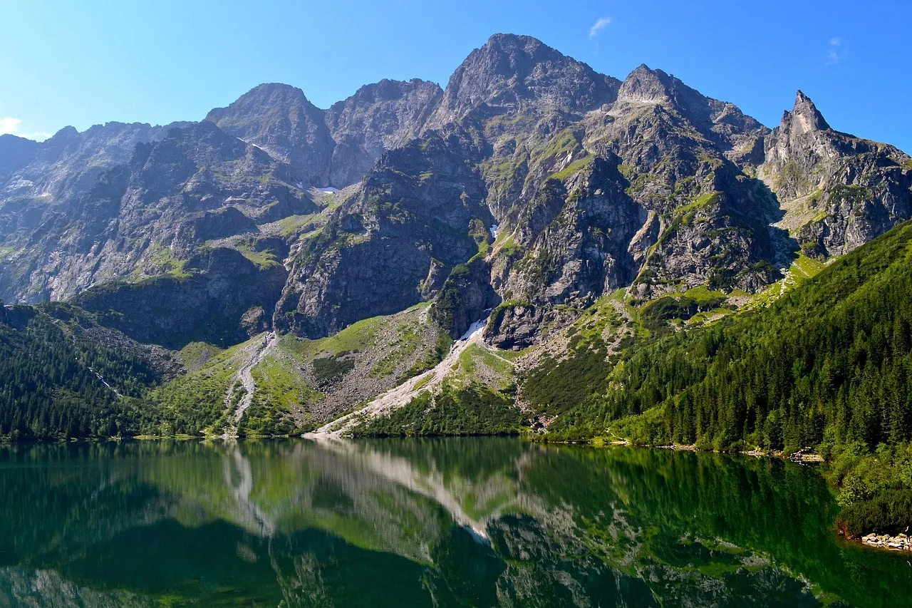 Morskie Oko lake reflecting the forested slopes and rocky peaks of the Tatra Mountains near Zakopane